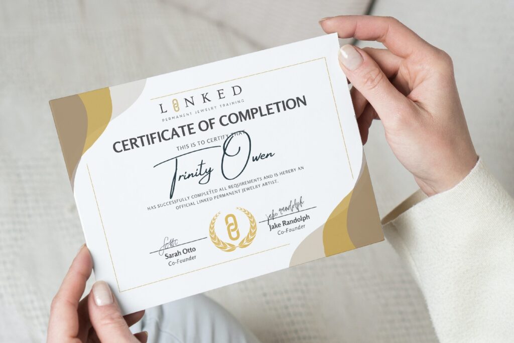 Trinity Owen holding LINKED certificate of completion