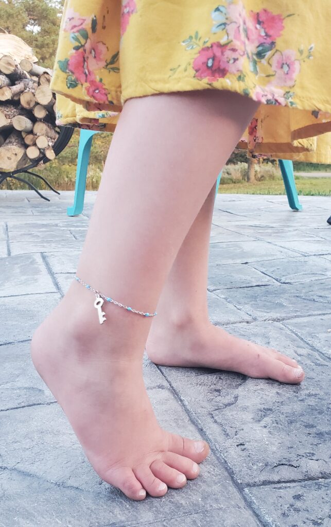 permanent jewelry anklet with a key charm