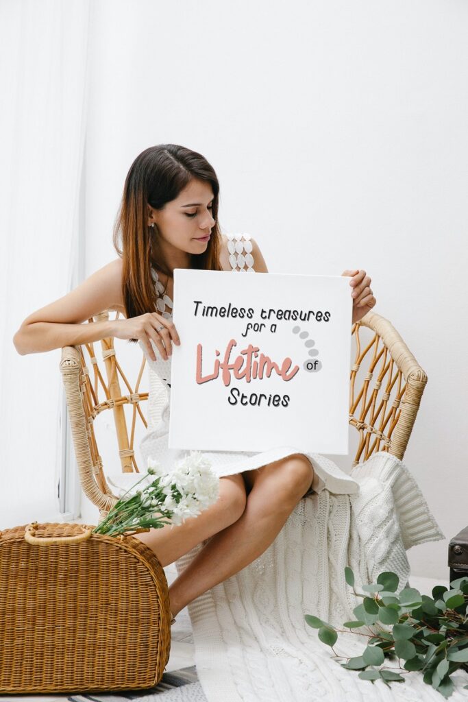 woman holding sign displaying permanent jewelry quote