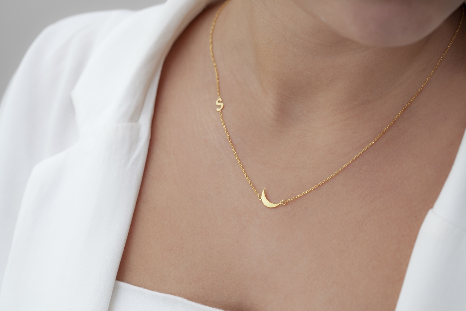 woman wearing gold permanent jewelry necklace