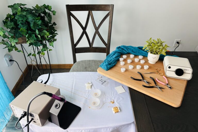 table full of permanent jewelry chains and supplies