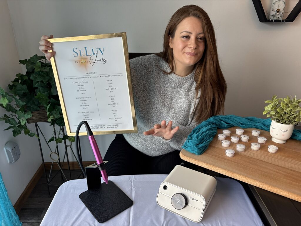 Trinity explaining permanent jewelry prices to customer