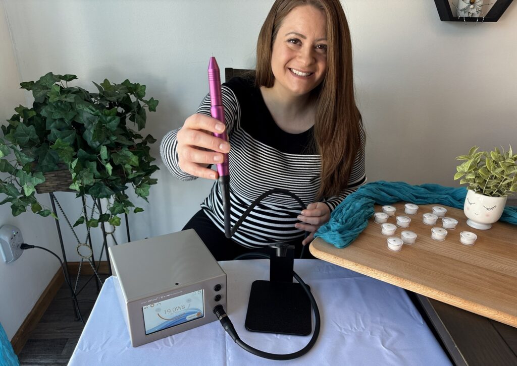 Trinity smiling holding stylus up