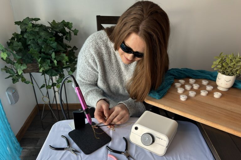 Trinity wearing IR shade 5 glasses while welding permanent jewelry