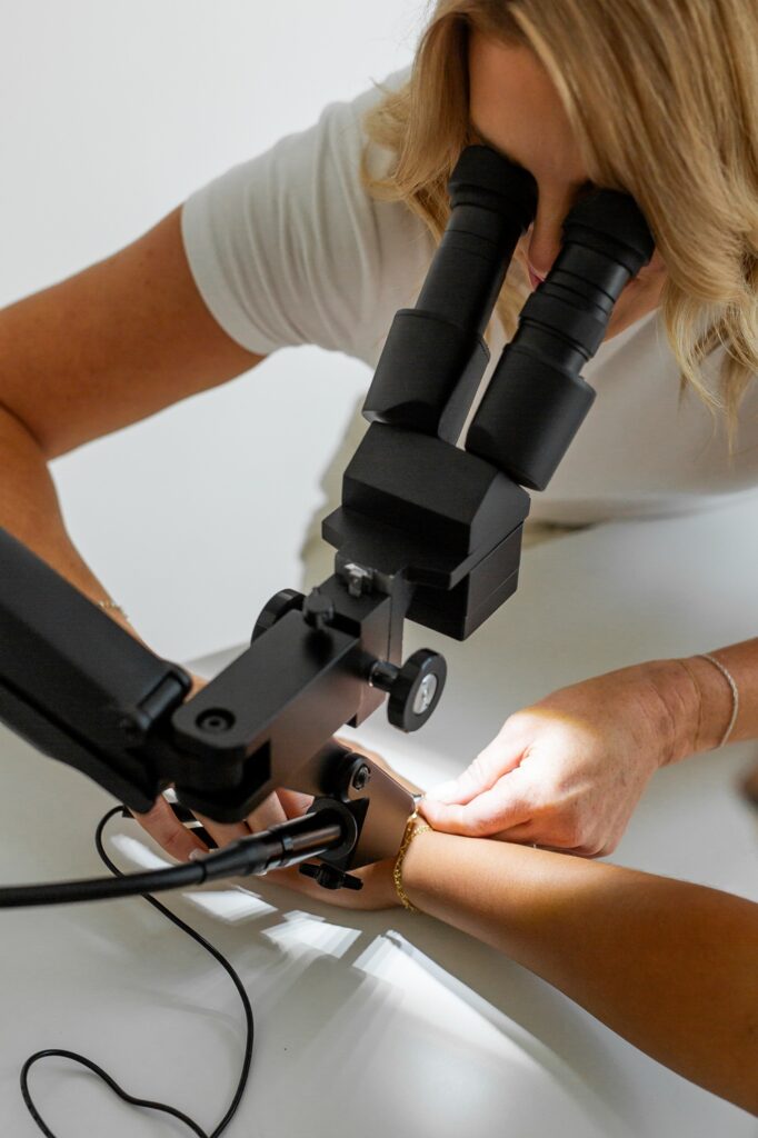 woman using the PJ Scope to weld permanent jewelry