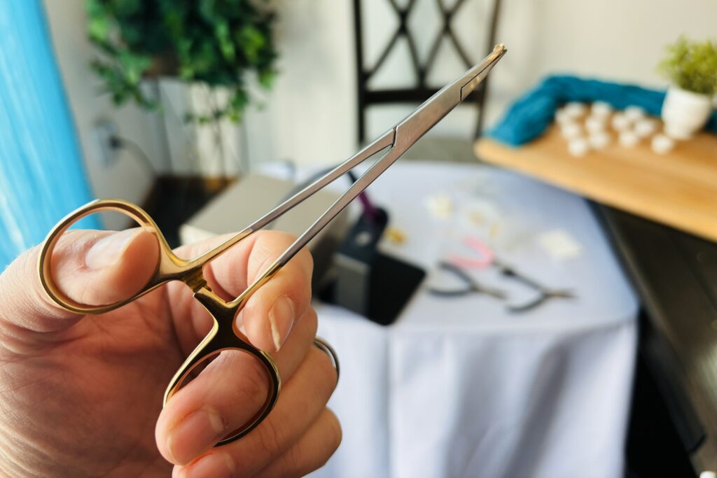 Trinity holding locking hemostats for permanent jewelry