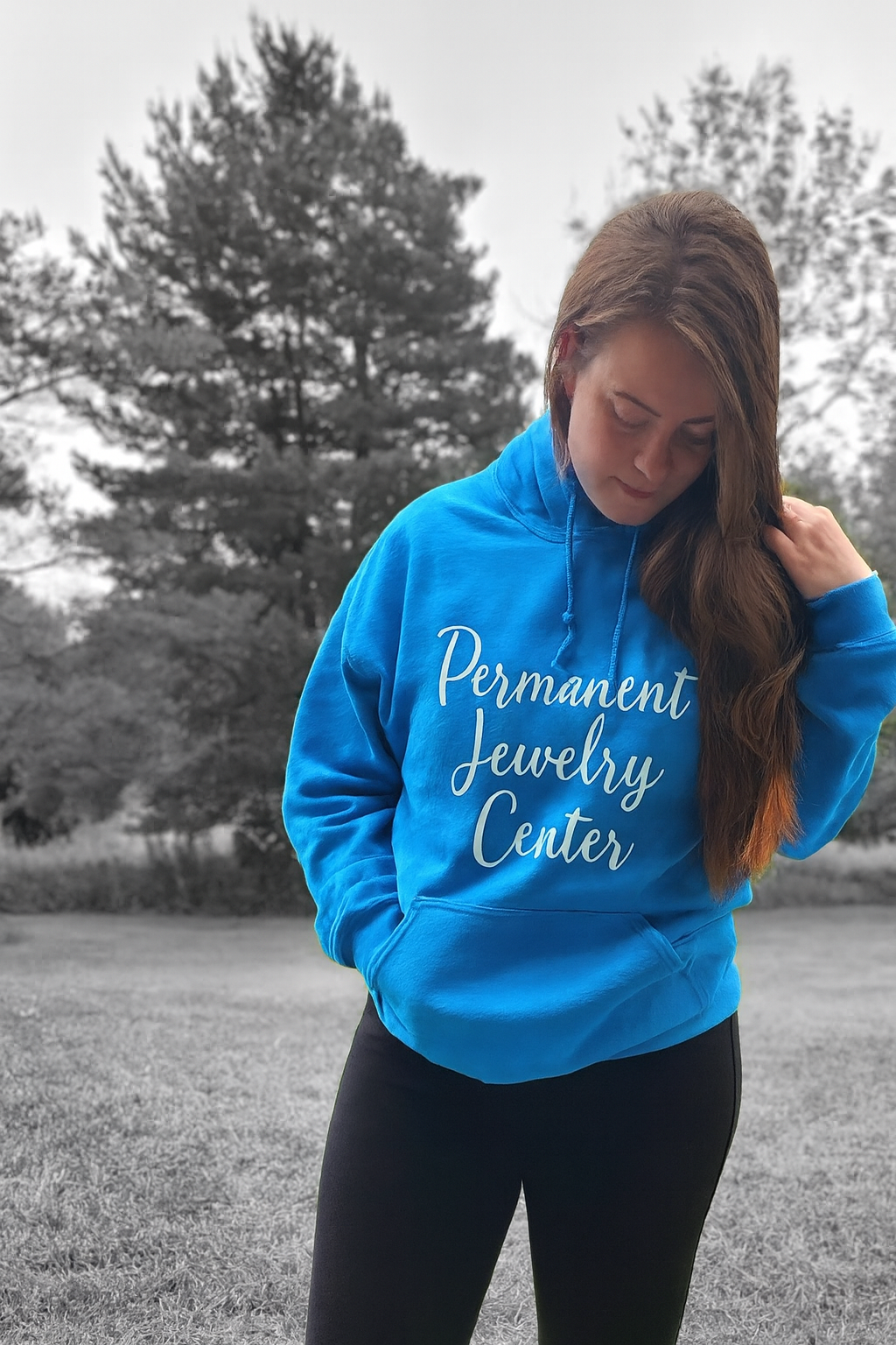 Trinity Owen, permanent jewelry artist, wearing blue hoodie that says Permanent Jewelry Center