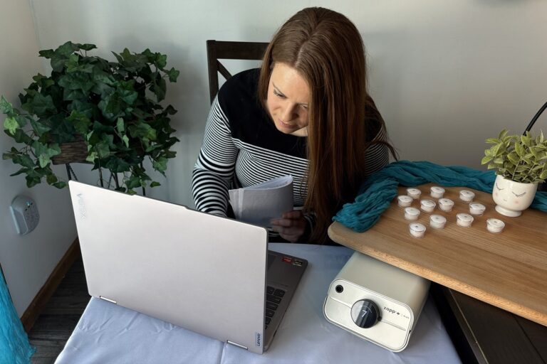 Trinity looking at laptop taking permanent jewelry training
