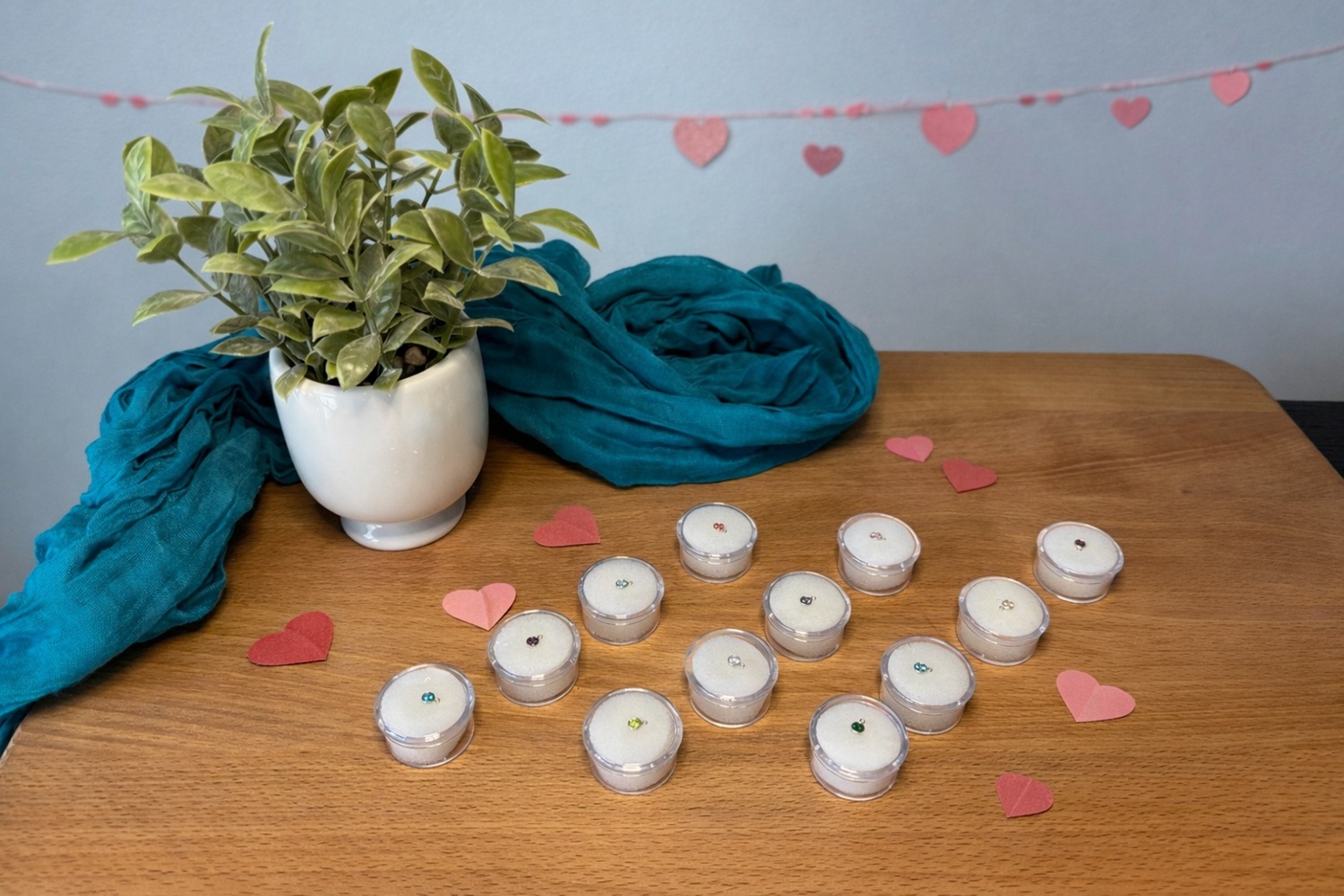 Valentine's Day permanent jewelry charms on a table