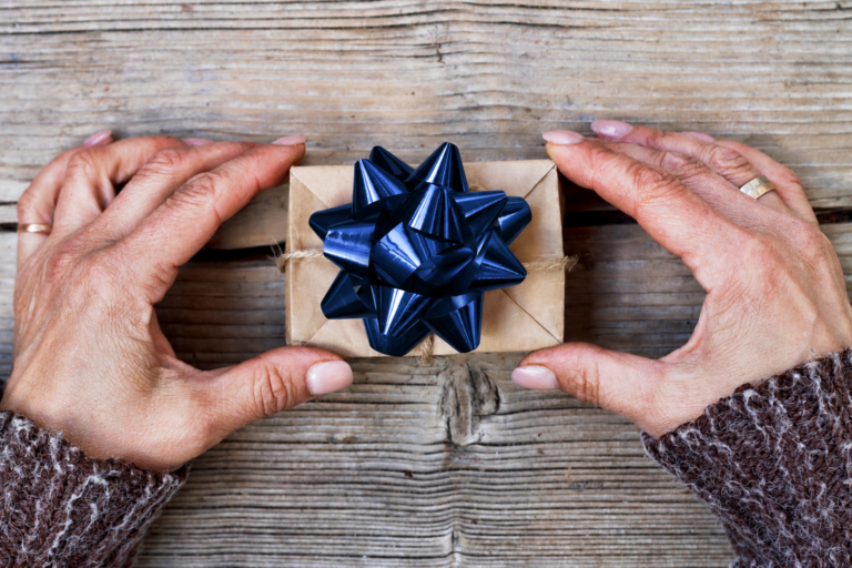 hands holding a permanent jewelry experience gift